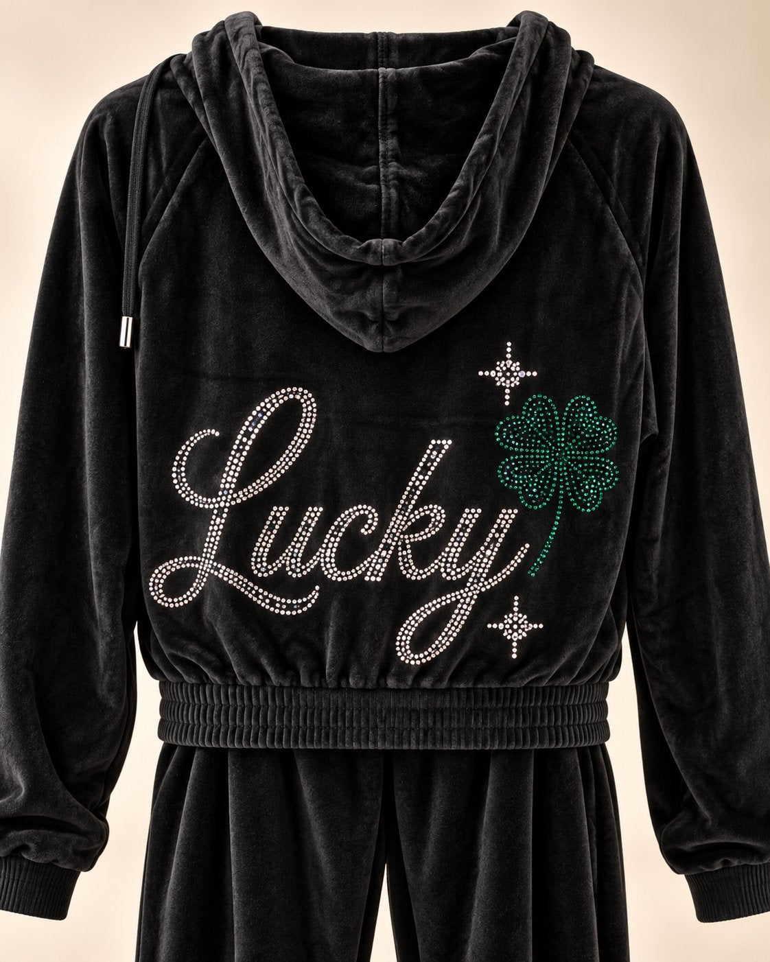 Black velvet tracksuit back view showing rhinestone Lucky design