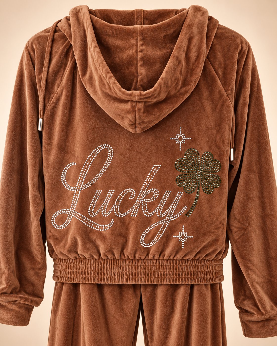 Espresso velvet tracksuit back view showing rhinestone Lucky design